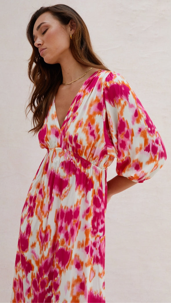 vibrant midi dress with a bold pink, orange, and white abstract print, featuring a deep V-neckline, three-quarter puff sleeves, and a cinched waist