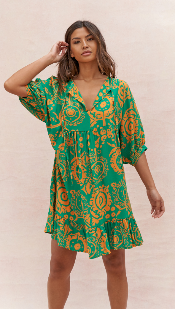 vibrant green and orange mini dress with a bold bohemian-inspired print, featuring a deep V-neckline, loose three-quarter sleeves, and a ruffled hem